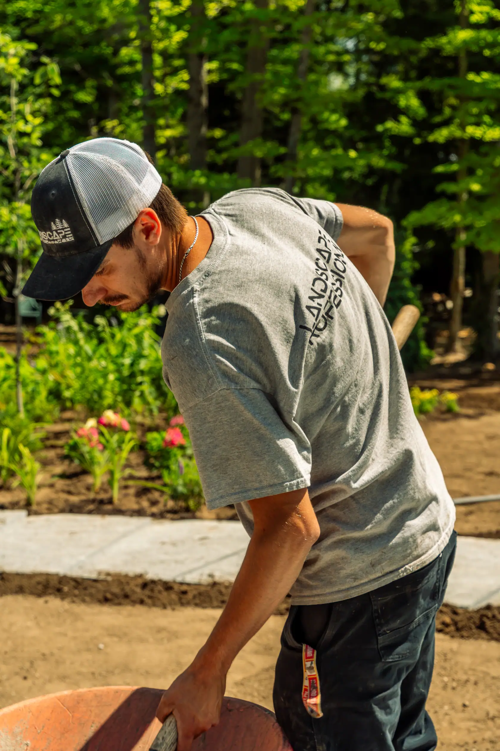 NuScape crew member working in a freshly planted garden bed