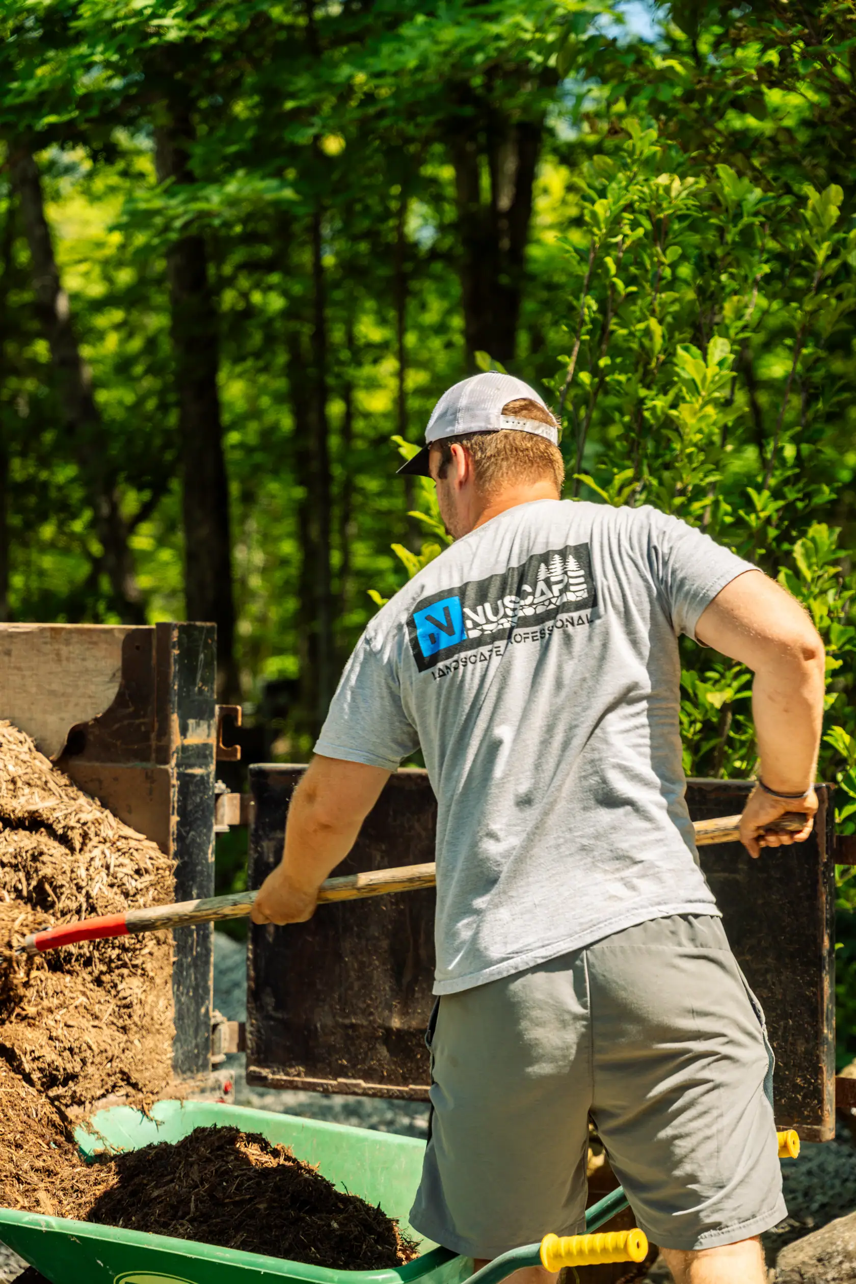 Crew loading mulch for garden bed installation